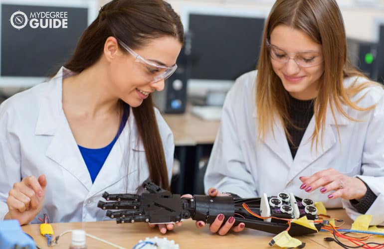 Plastic Engineers examining a mechanical plastic hand