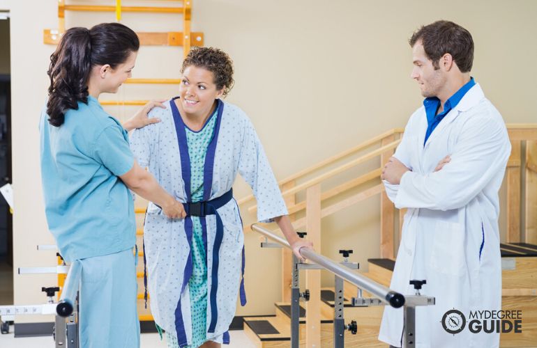 Occupational Therapy Assistant assisting a patient while doctor is observing