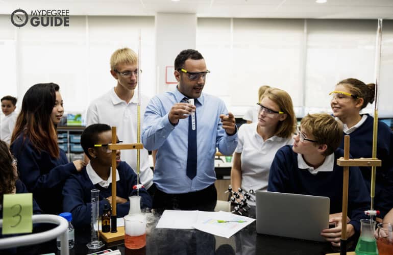 A high school teacher interacting with students