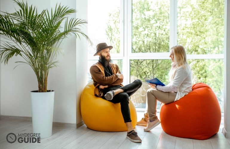 psychologist listening to her patient in her office during therapy session