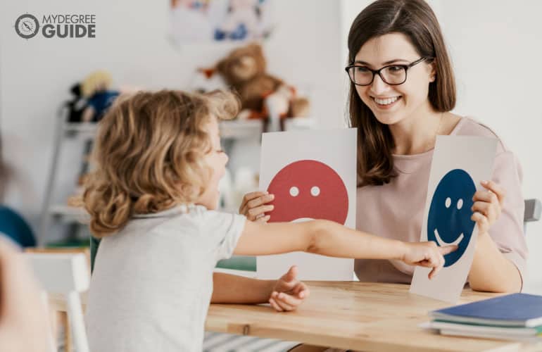 female psychologist having a therapy session with a child