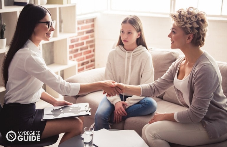 psychologist shaking hands with a parent