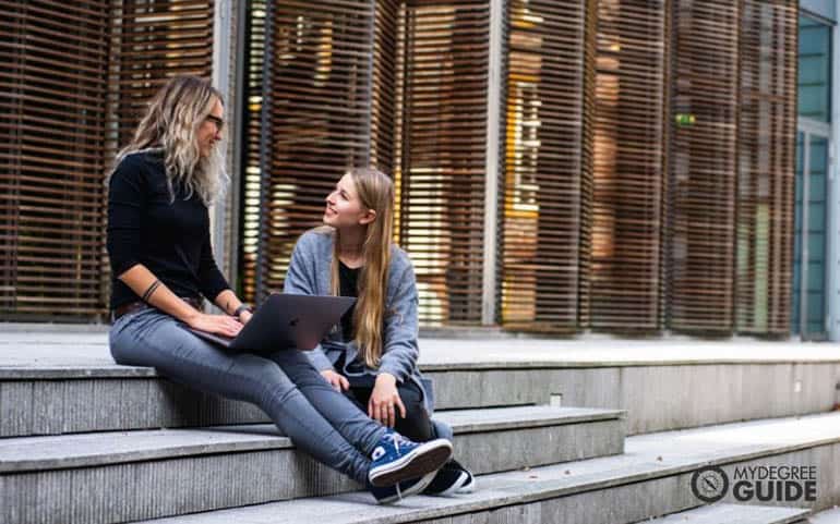 university students talking on the steps