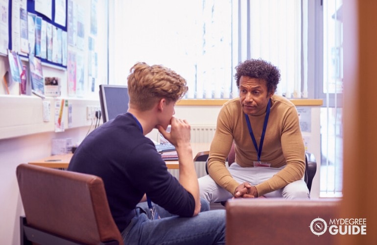 school psychologist talking to a young student