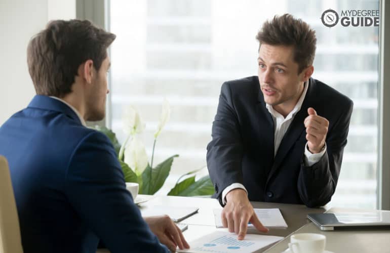 public administration consultant talking to a colleague