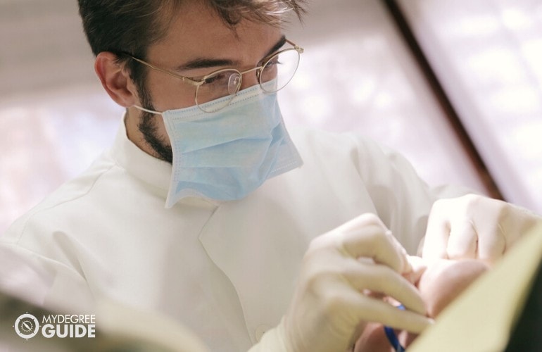 Public Health dentist working in his clinic