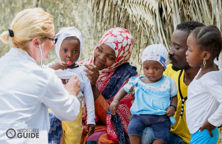 doctor checking on a family during community visit