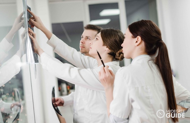 team of doctors looking at an x-ray result