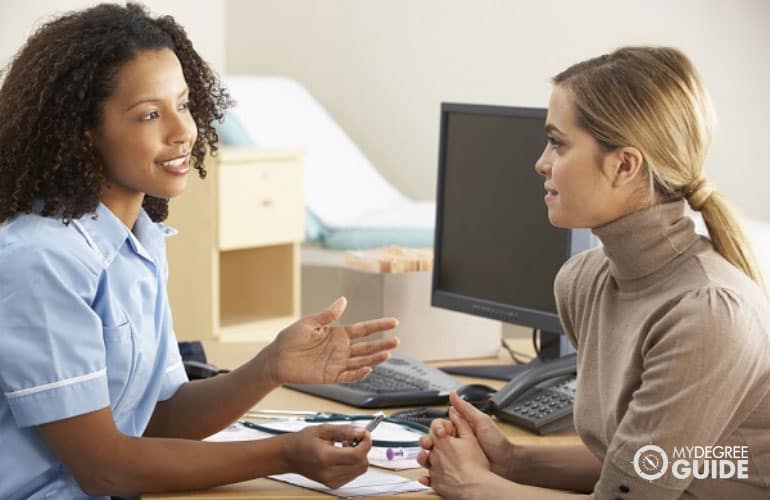 nurse talking to a patient in hospital