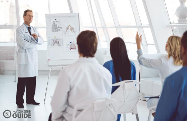 head doctor discussing during a seminar with other healthcare professionals