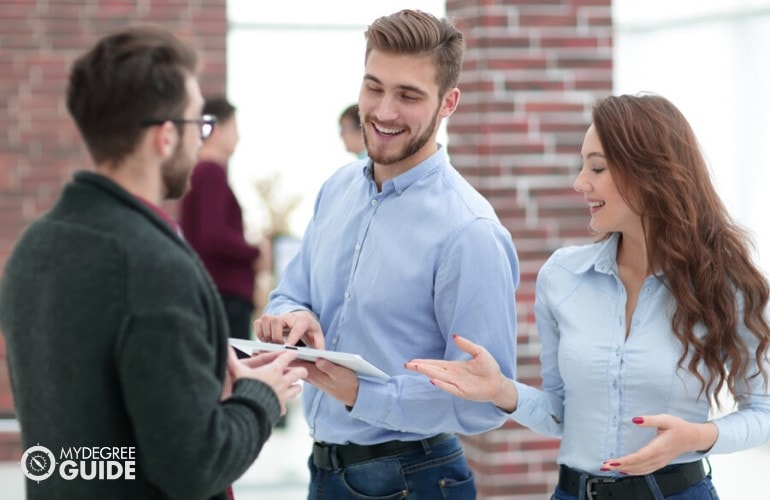 business professionals talking to colleague in an office