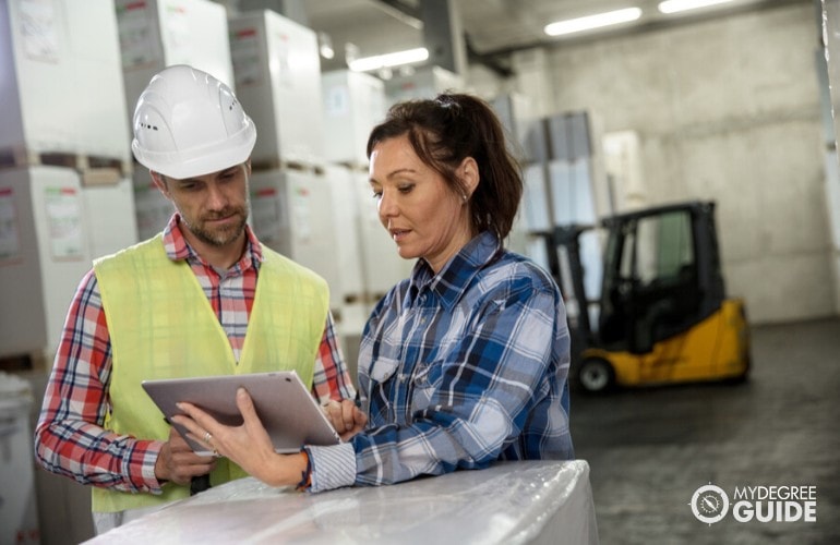 purchasing manager talking to a warehouse employee