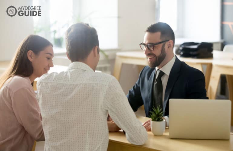 real estate agent talking to a couple