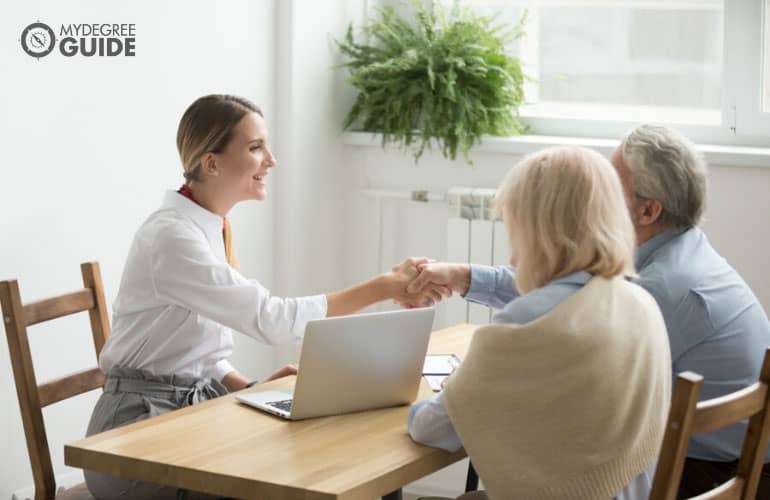 Real Estate broker closing a deal with a senior couple