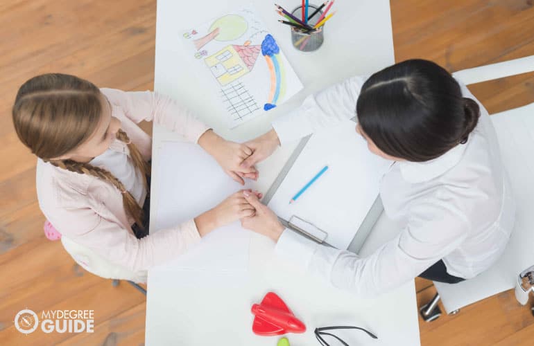 psychologist talking to a girl patient