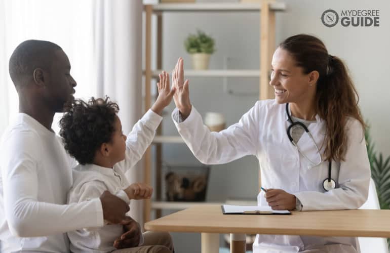 female counselor talking to a father and child in an office at a hospital