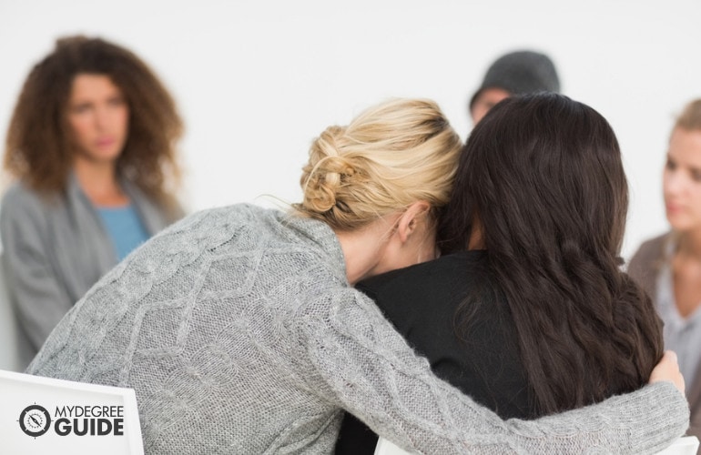 rehab counselor comforting a patient during an in-patient rehab program