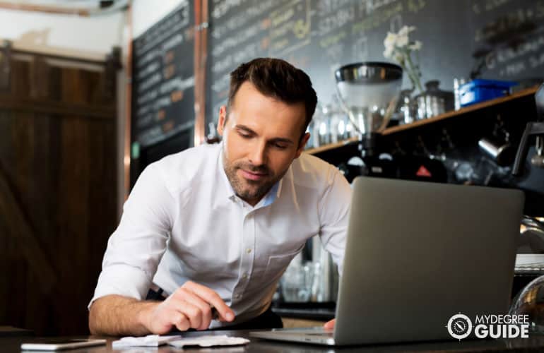 Restaurant Manager working on his laptop