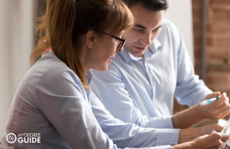 Certified Financial Planner talking to a colleague 