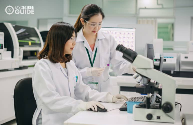 healthcare professionals using medical equipment in a safety lab