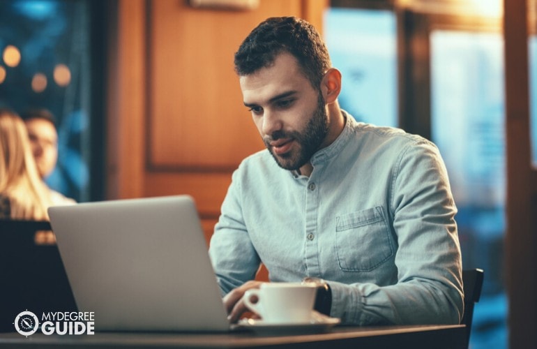 Search Engine Marketing Specialist working in a cafe