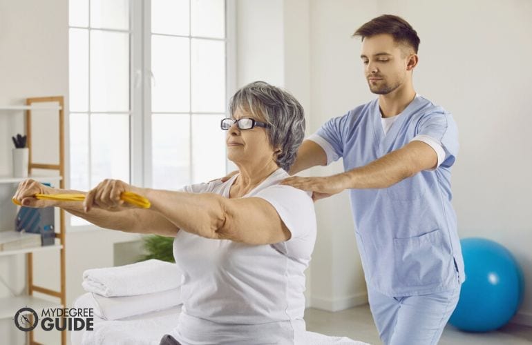 Occupational Therapist guiding a patient on her posture