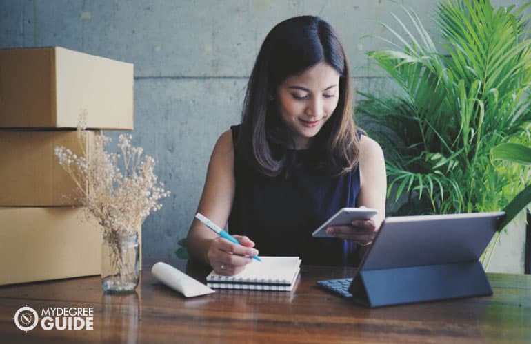 small business owner checking orders on her phone