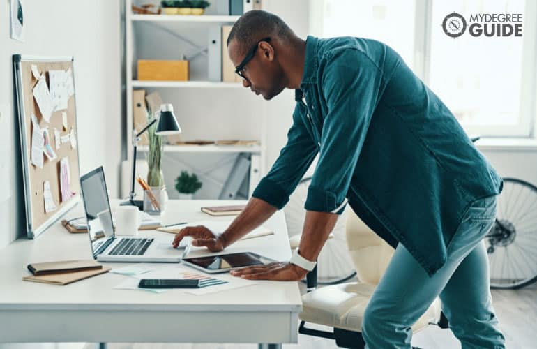 male operations manager working on his computer