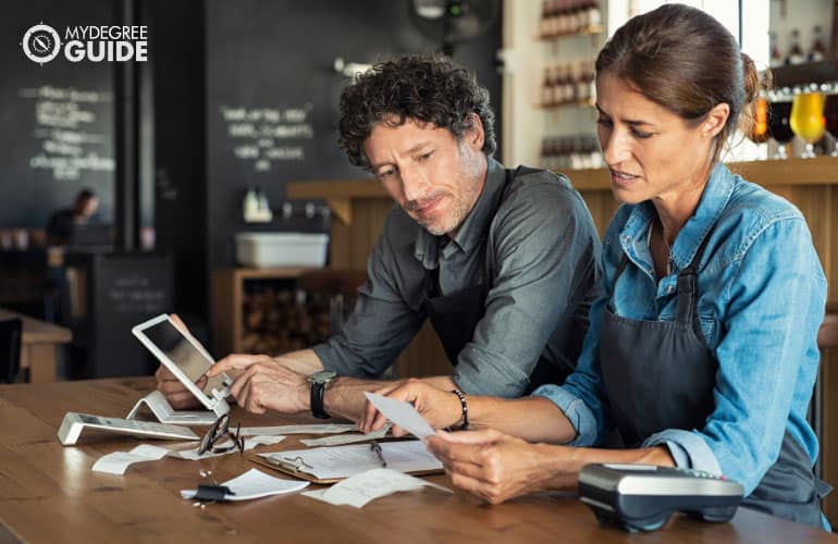 business owner checking receipts at store