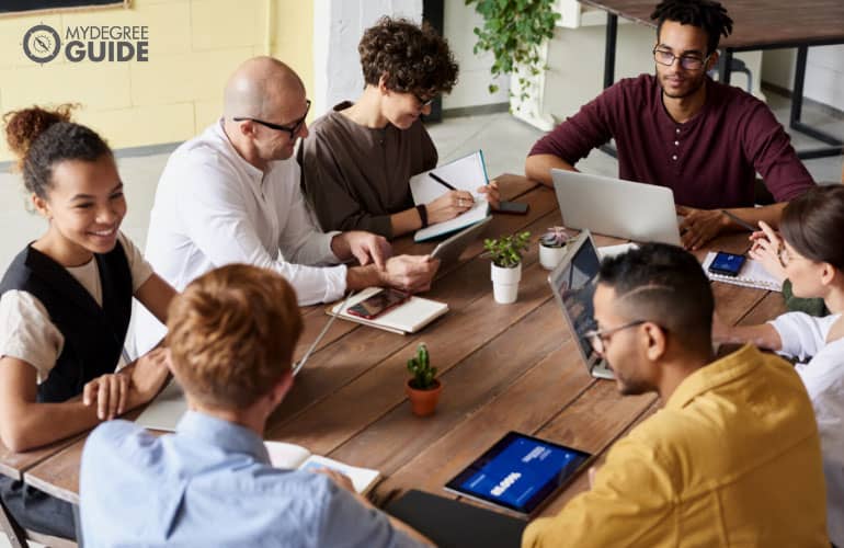 team of professionals in a non-profit agency discussing during a meeting