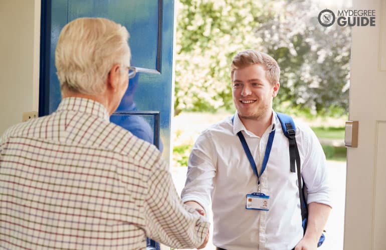 social worker visiting the house of an elderly man