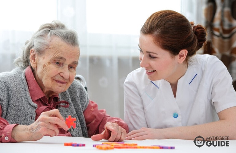 social worker caring an elderly woman in a foster home