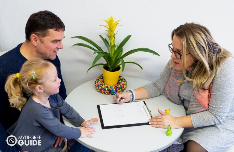 social worker talking to father and child