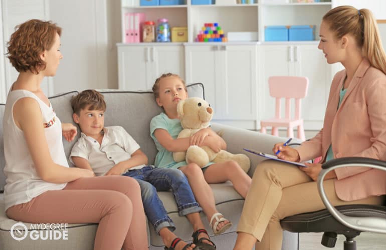 social worker talking to a family during home visit