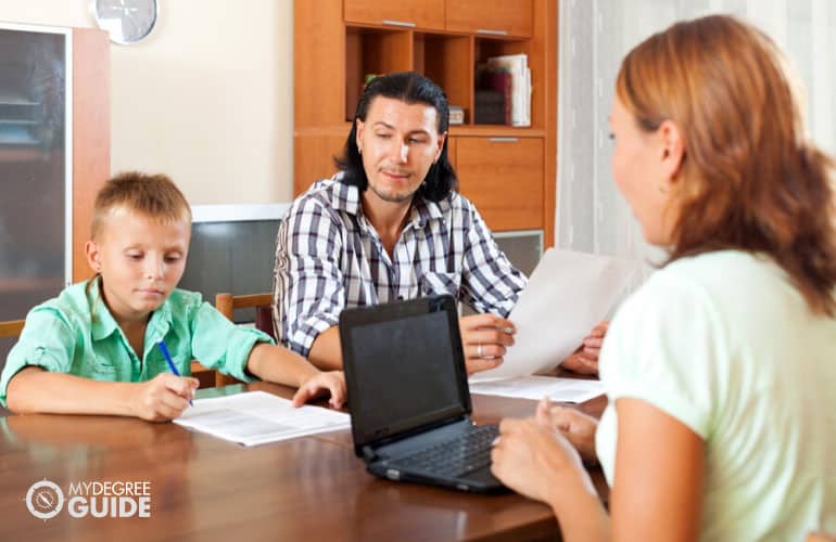 father and son filling questionnaire for social worker