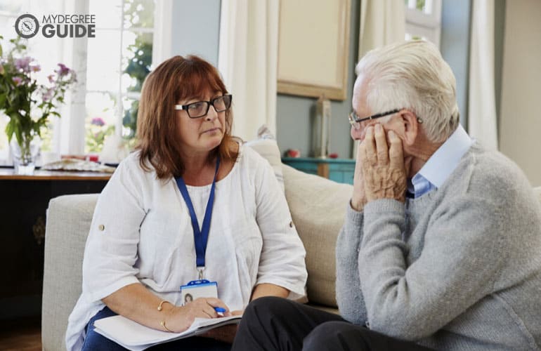 social worker visiting an elderly man