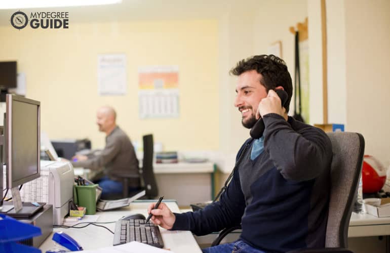 office clerk talking to a client on the phone