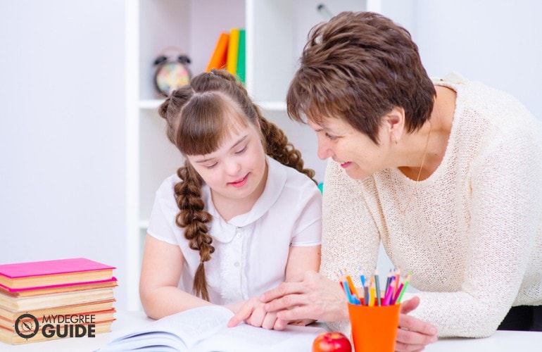 Special Education teacher teaching a child with down syndrome