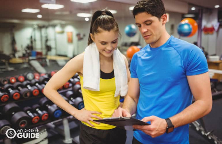trainer showing the exercises to a client