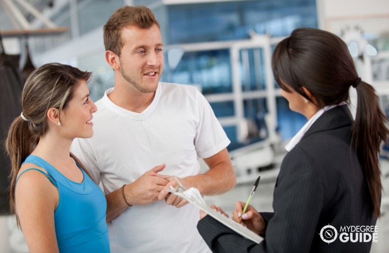 sports manager talking to athletes in a a gym