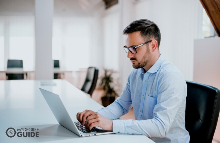 male professional studying on his computer