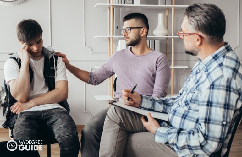 substance abuse counselor listening to his patients during counseling