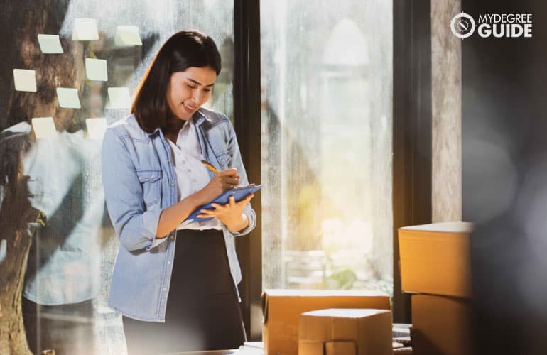 female employee looking at checklist on her hand