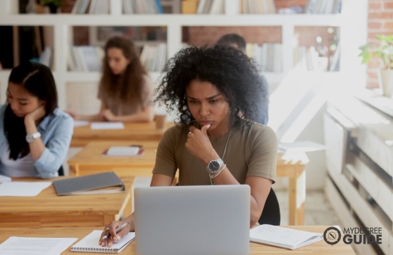 female student thinking in class