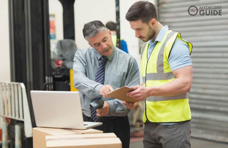 logistics manager checking the products in a factory