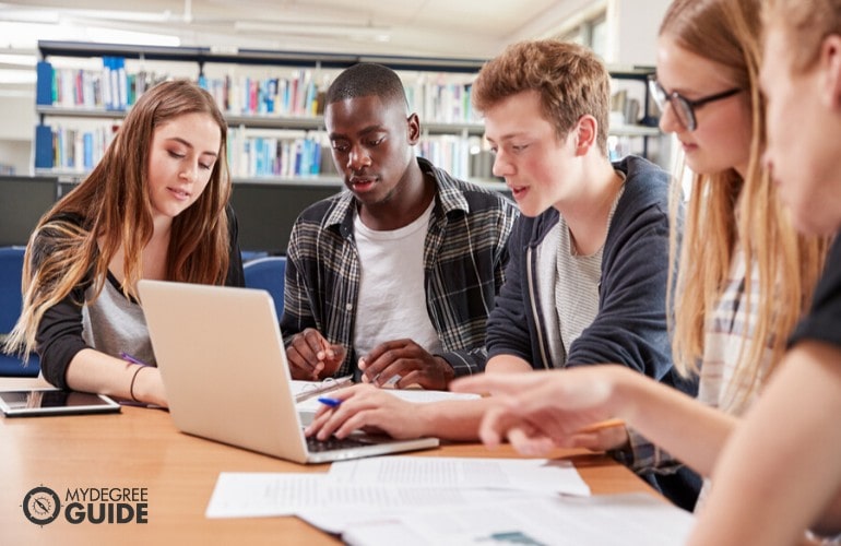 supply chain management students studying in library