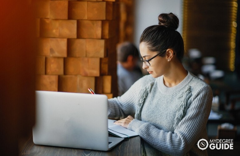 supply chain management student studying at a cafe