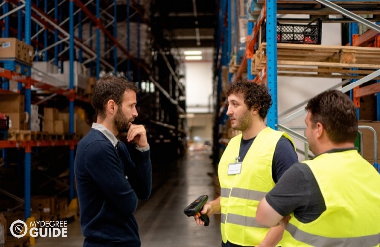 supply chain manager giving instructions to his staff