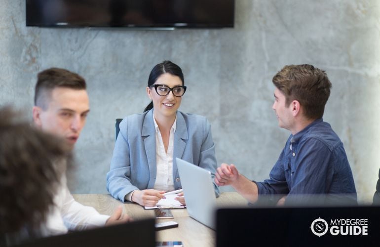 HR employee mentoring a colleague in the office