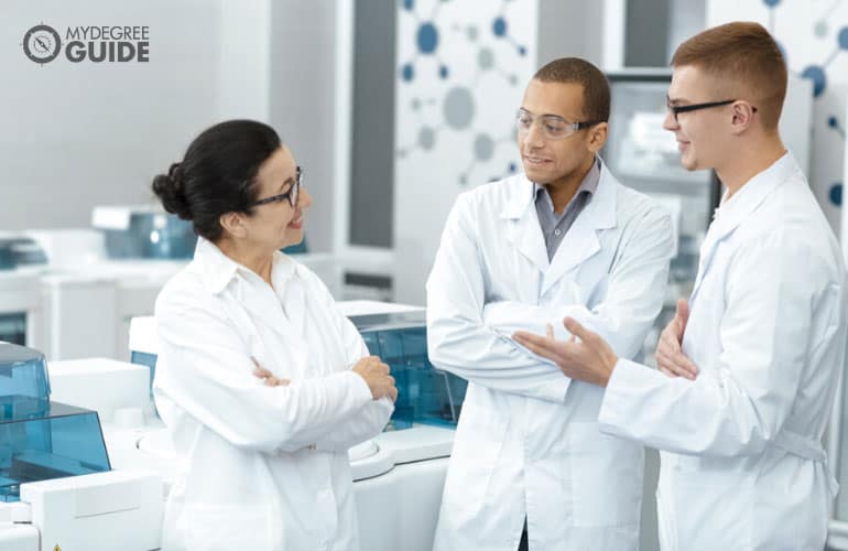 team of healthcare professionals talking in a hospital office